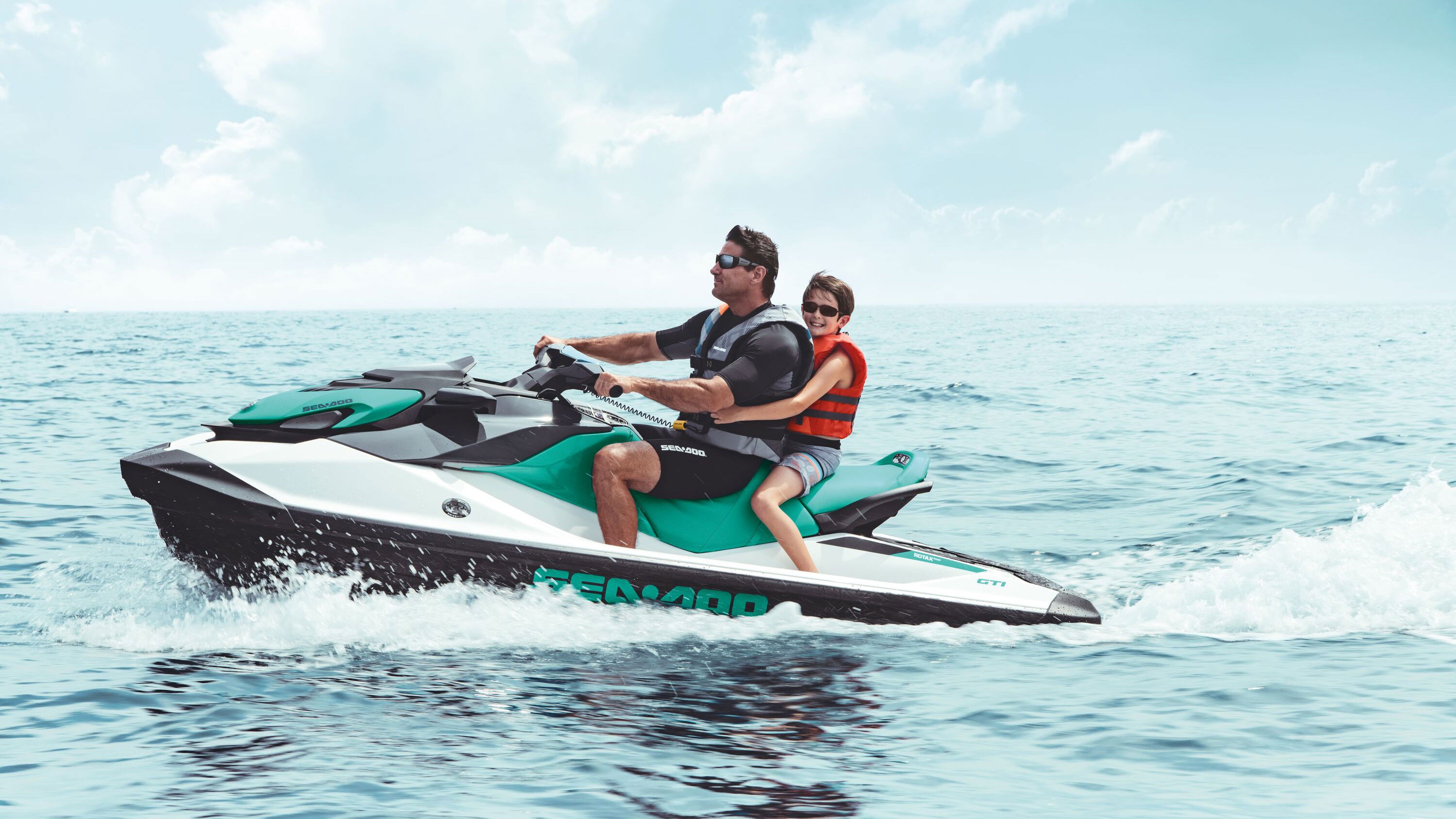 Father and son riding a Sea-Doo GTI 90