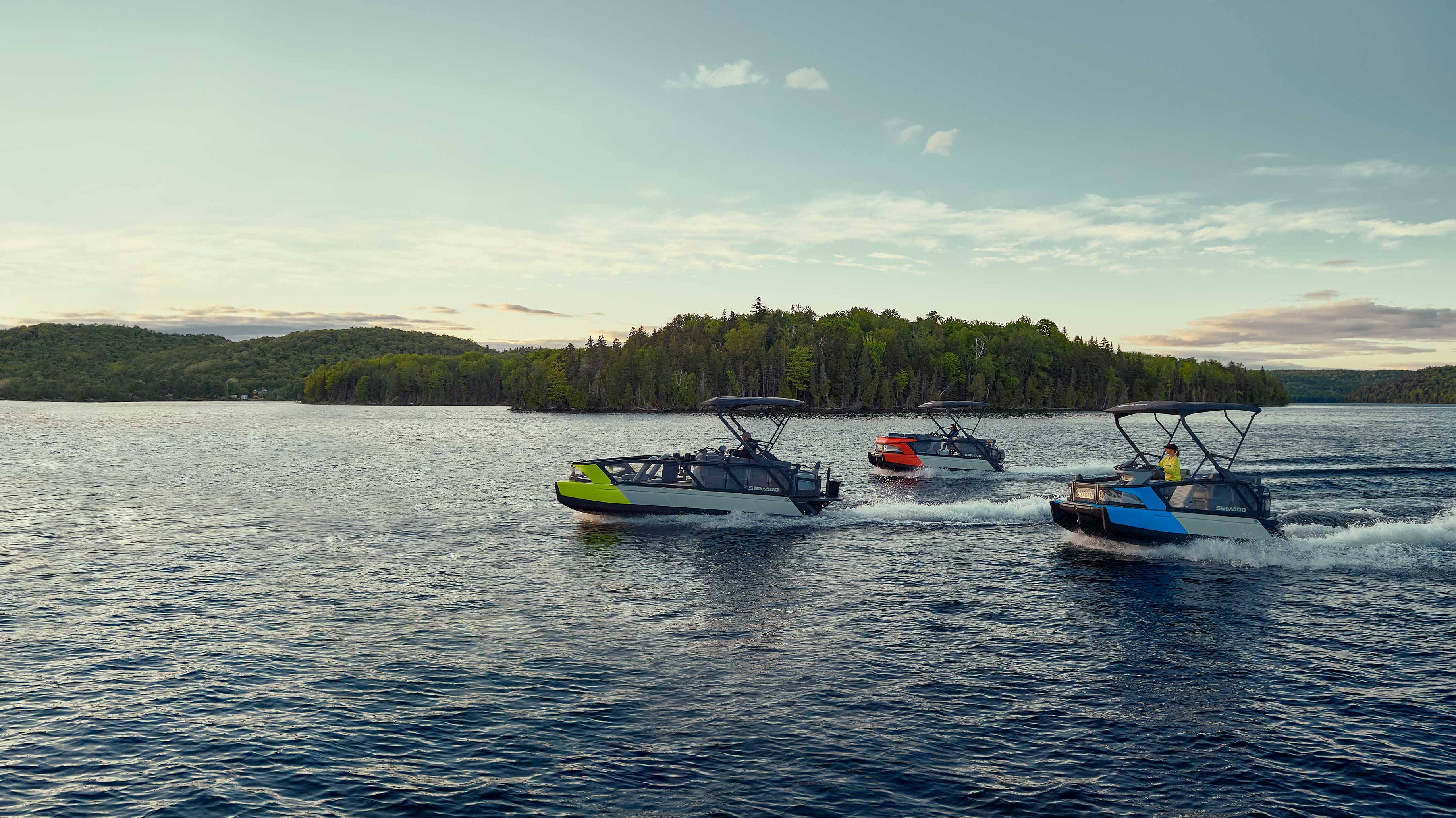 Three Sea-Doo switch cruising on a lake