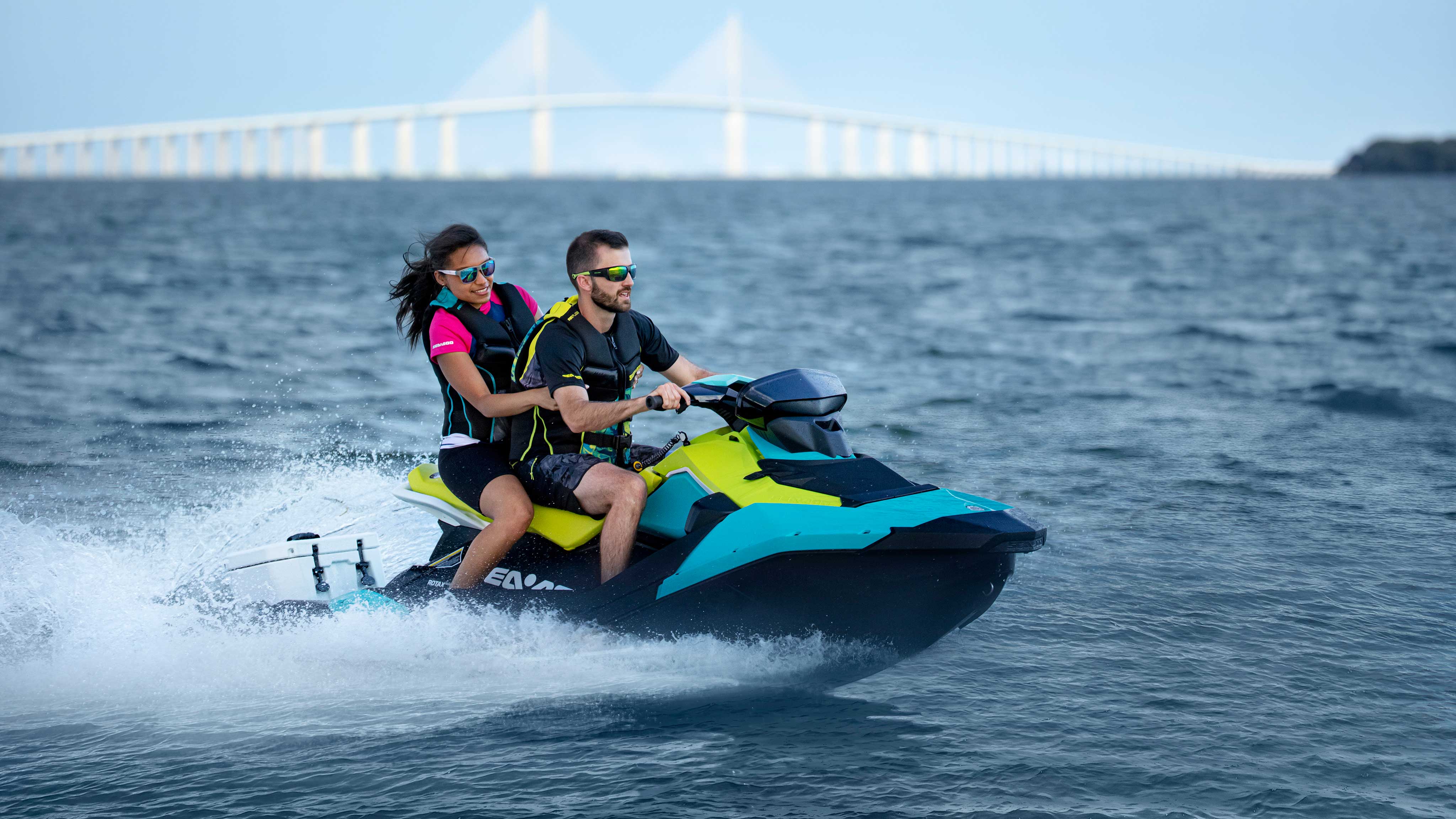 Couple riding the new Sea-Doo SPARK with a LinQ Cooler
