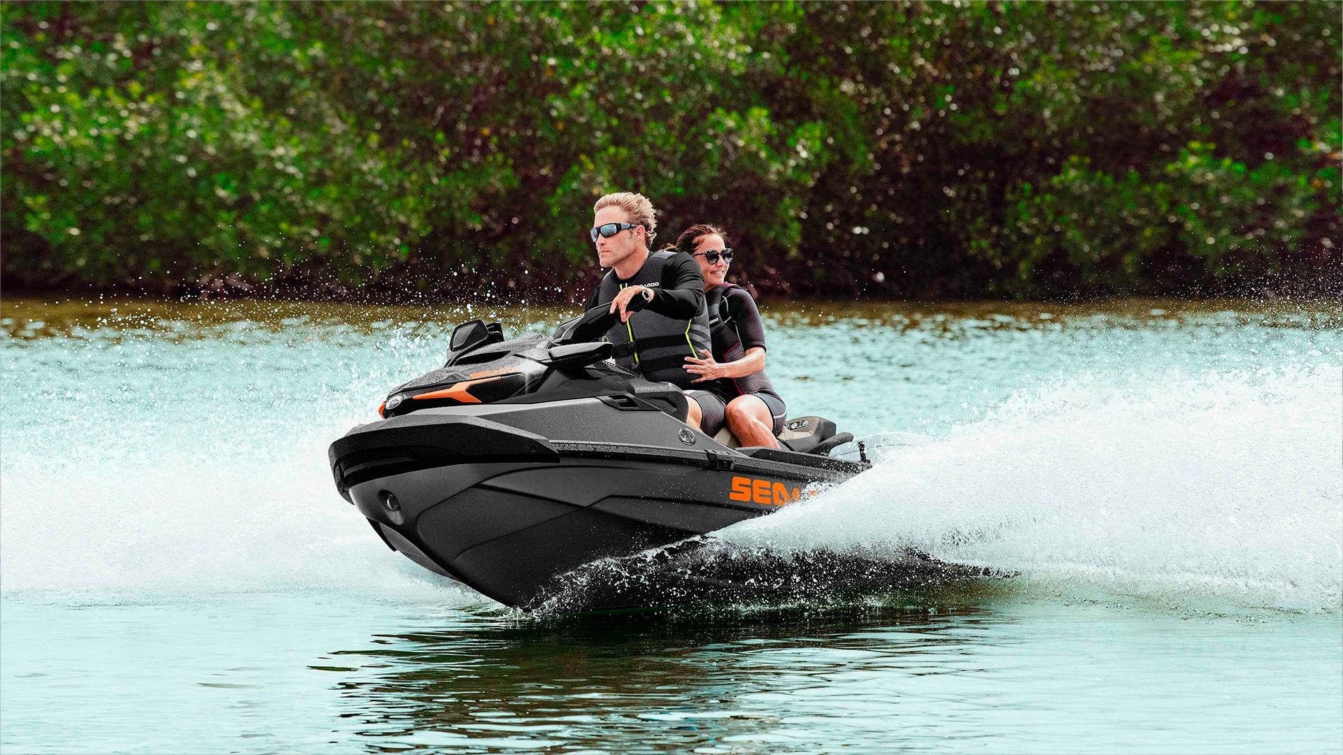 Dad and his daughter riding a Sea-Doo GTX personal watercraft