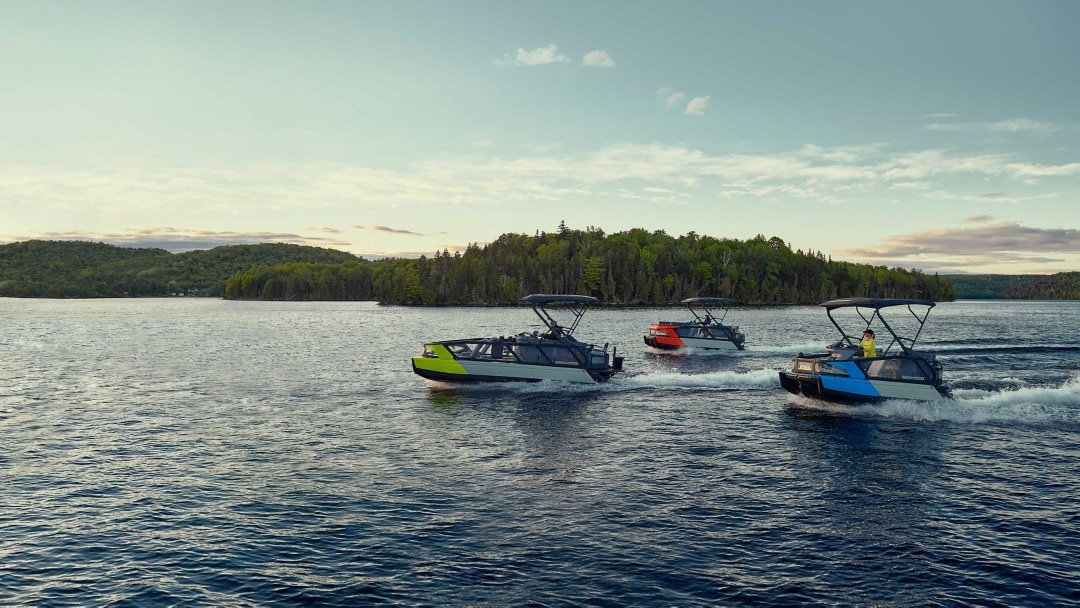 Three Sea-Doo Switch pontoon boats on a lake