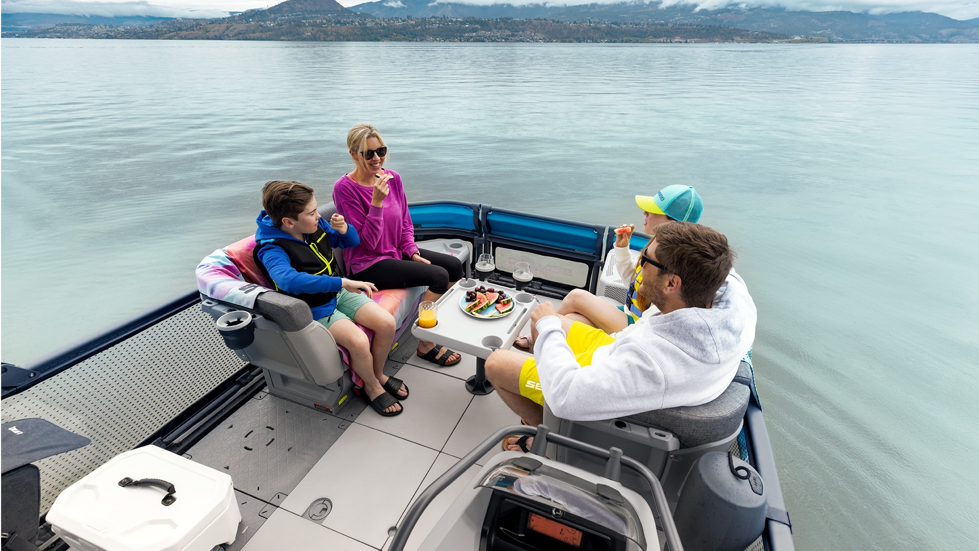 Family enjoying a lunch break on a Sea-Doo SWITCH pontoon