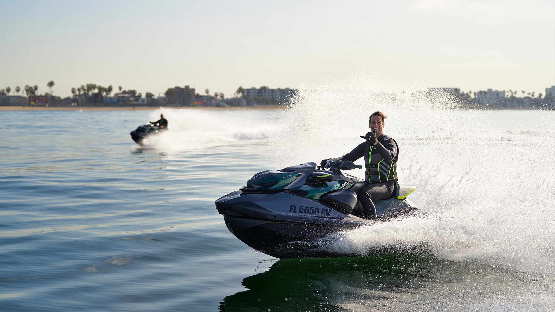 Daniel Ricciardo driving his Sea-Doo personal watercraft with Anthony Radetic catching up to him on his PWC