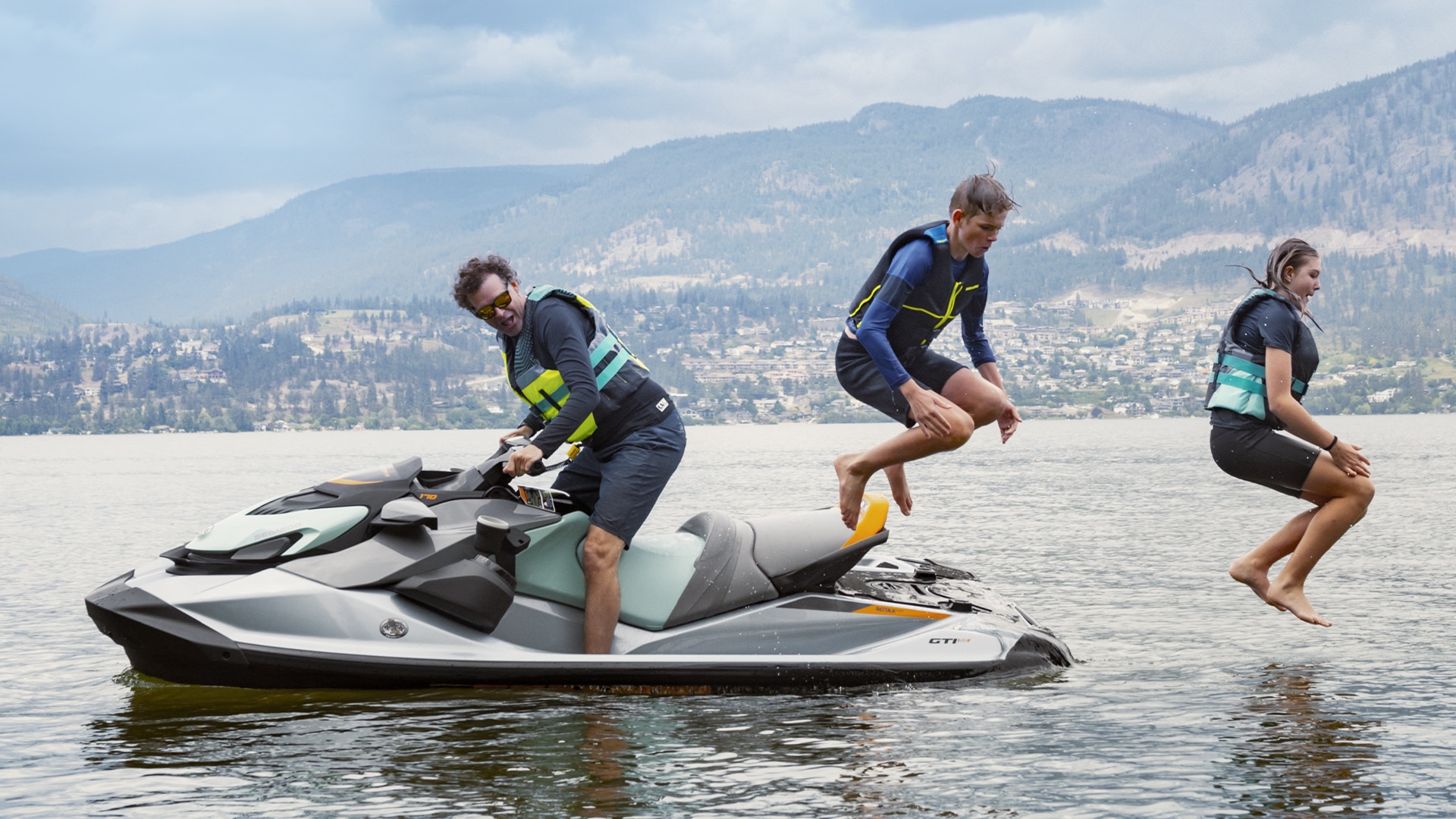 Riders jump off a Sea-Doo watercraft