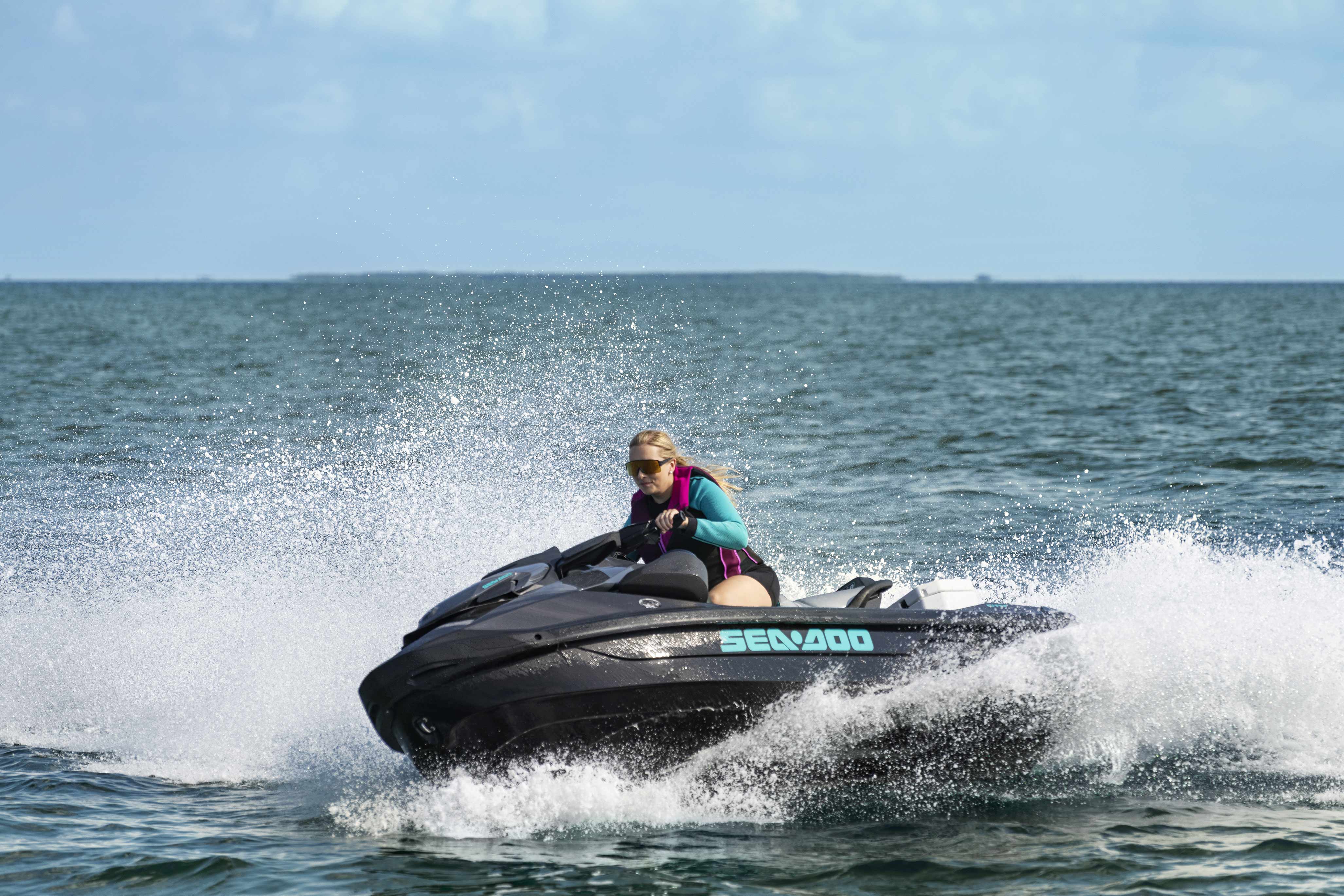 Woman riding a Sea-Doo GTR performance personal watercraft