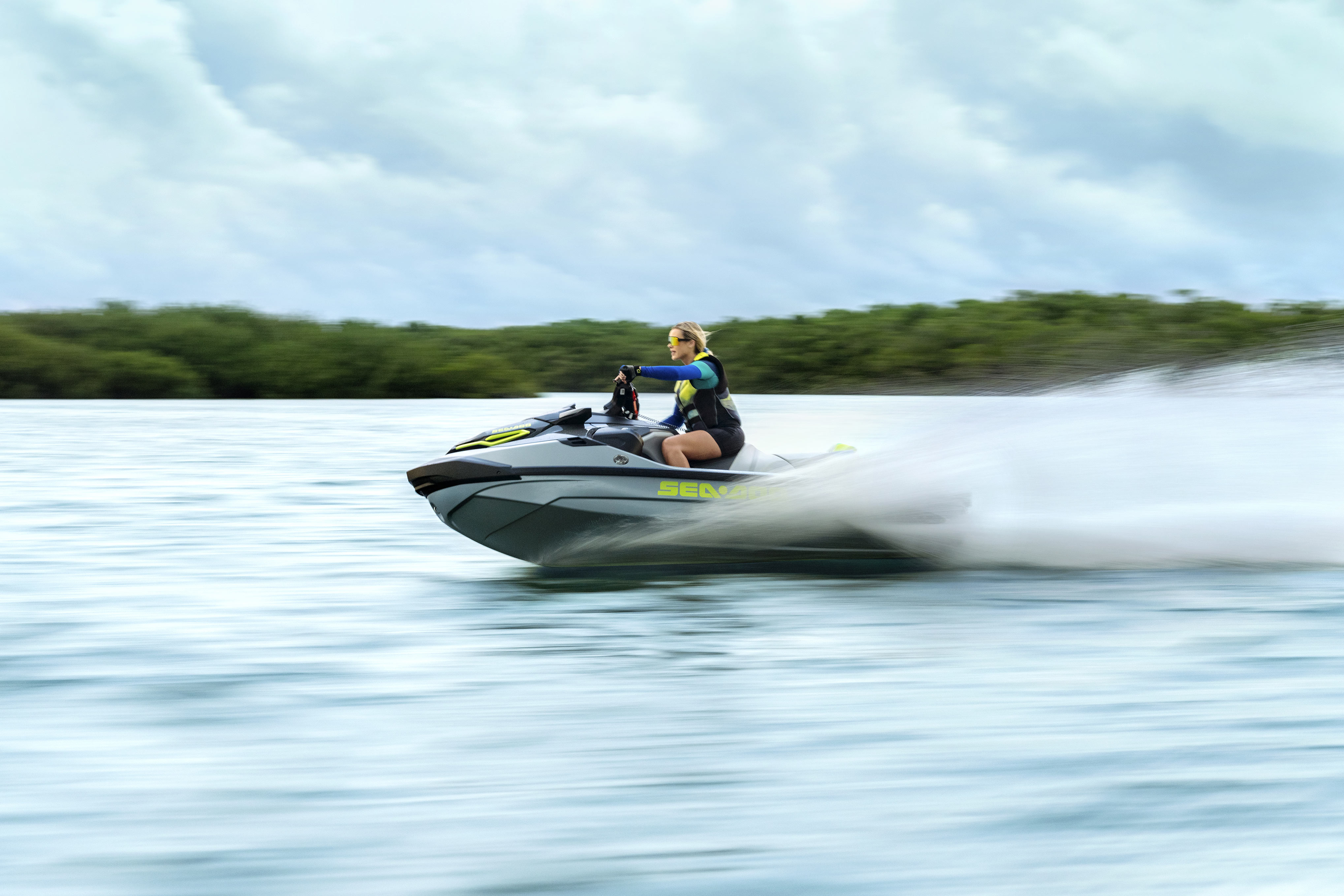 Woman riding a 2024 Sea-Doo RXT-X at full speed