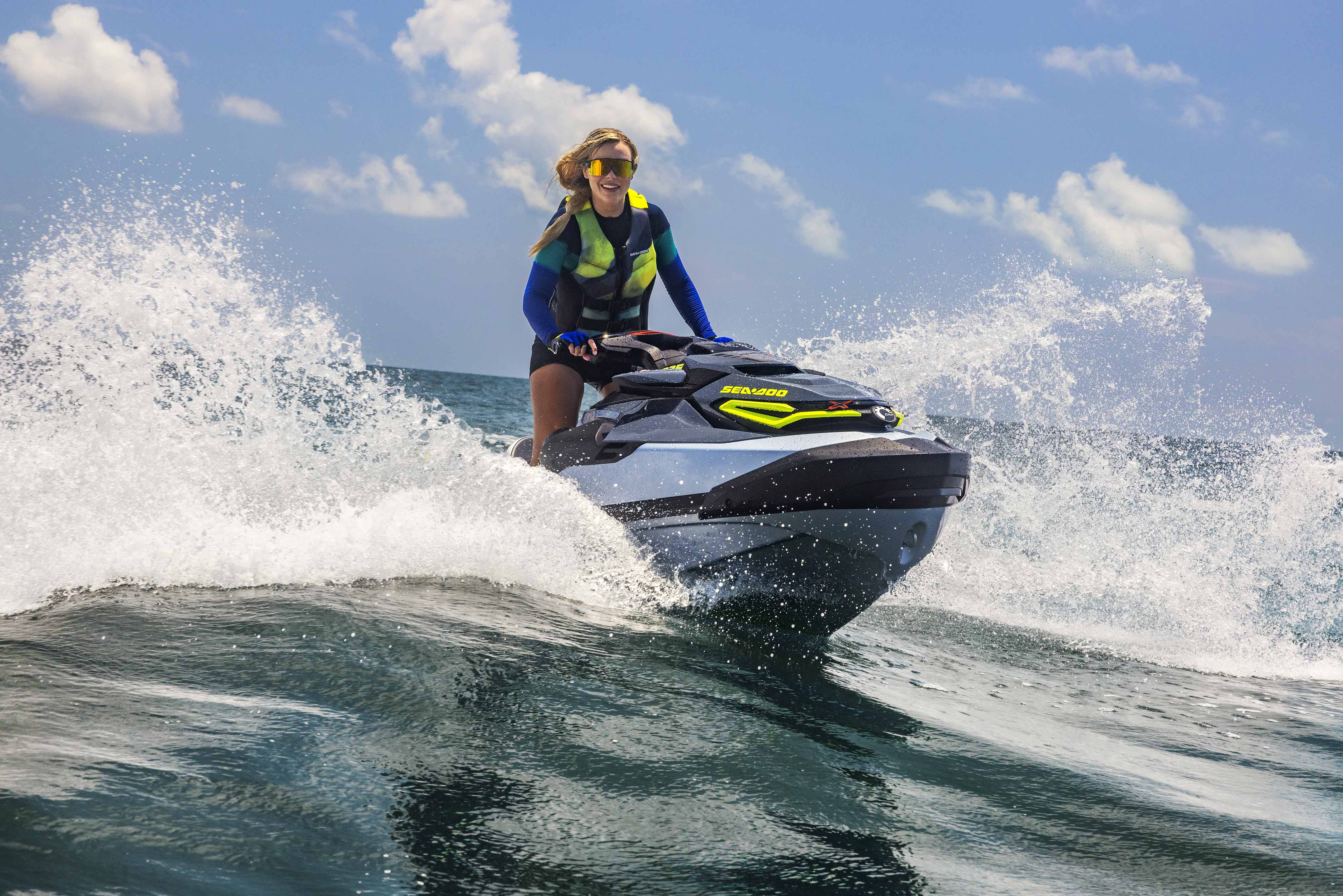 Woman riding a Sea-Doo RXT-X performance personal watercraft