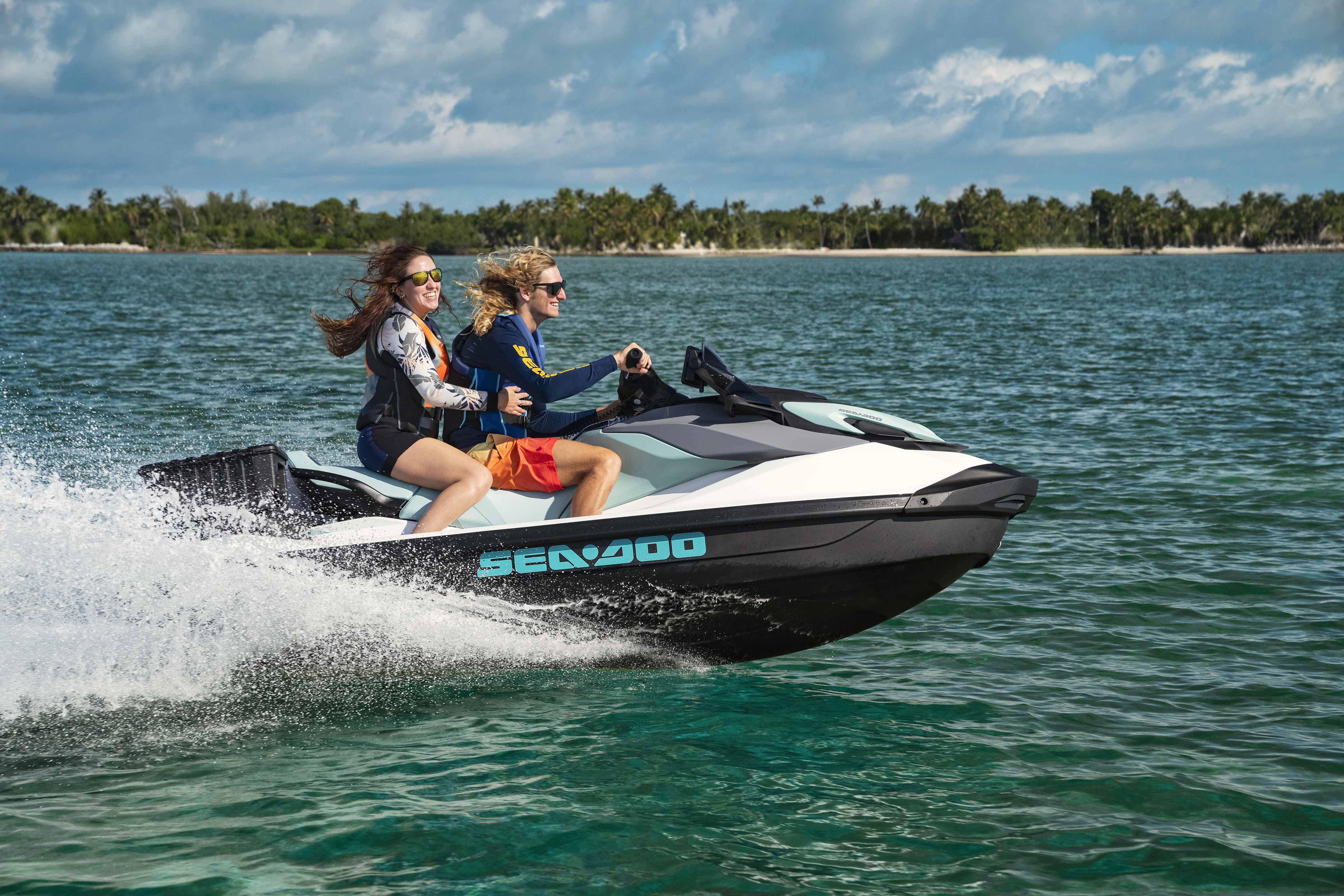 Two women riding on a Sea-Doo GTI 130 personal watercraft