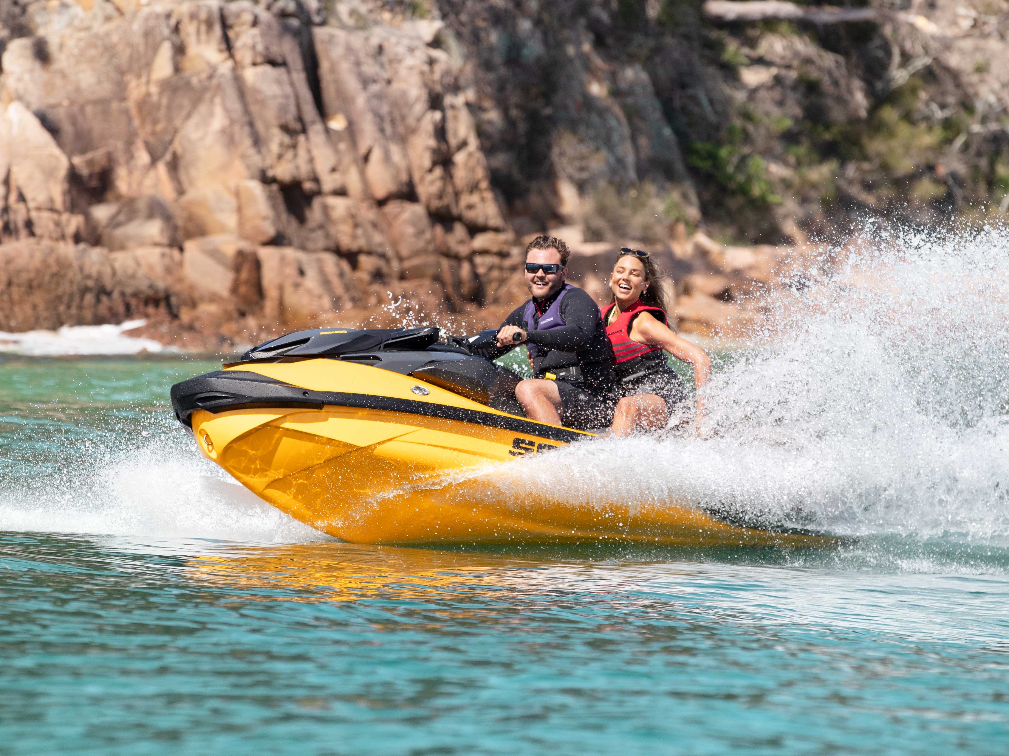 Couple enjoying Personal Watercraft ride with their Sea-Doo RXP-X