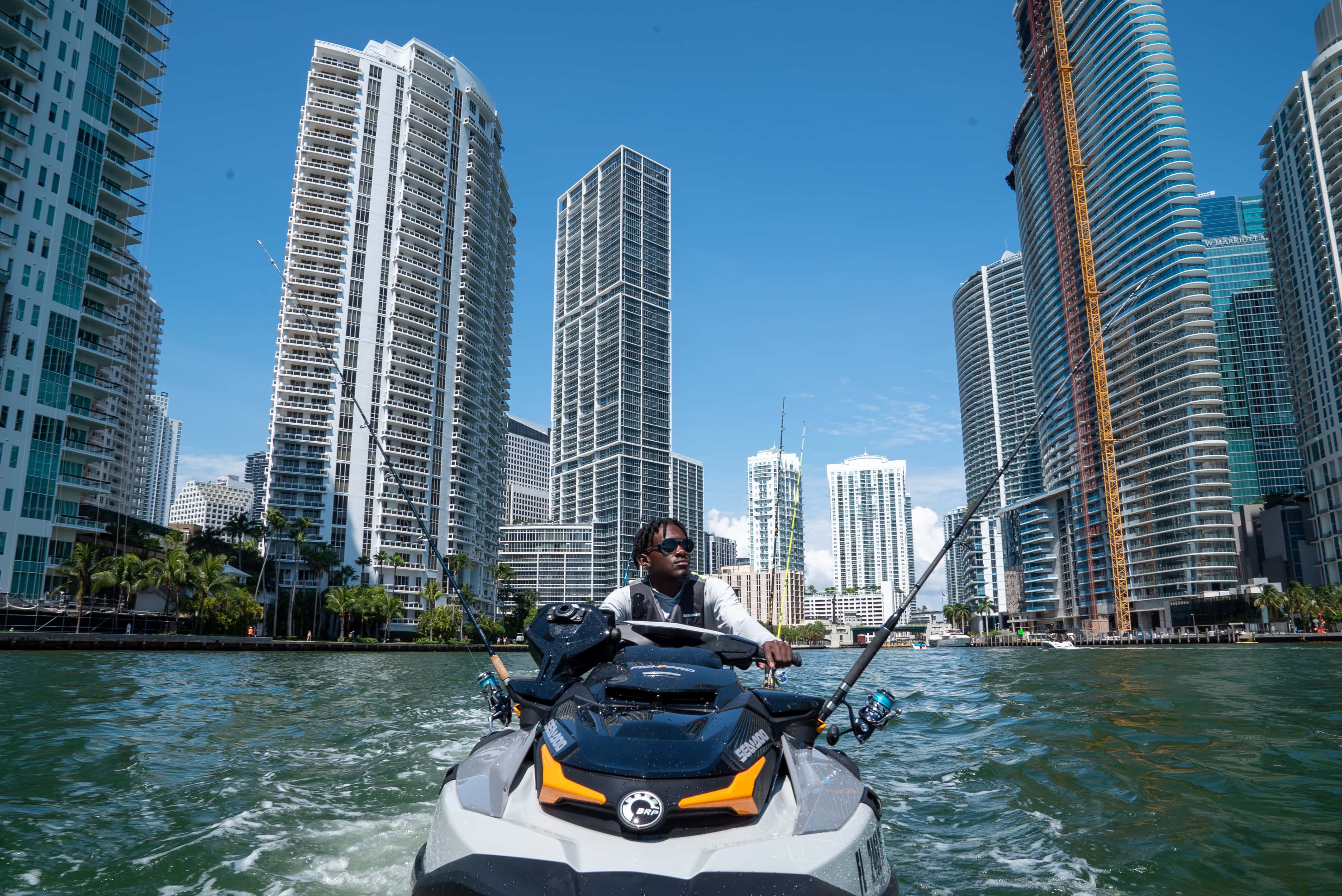 Emmanuel Williams riding on Sea-Doo FISHPRO with a city in the background