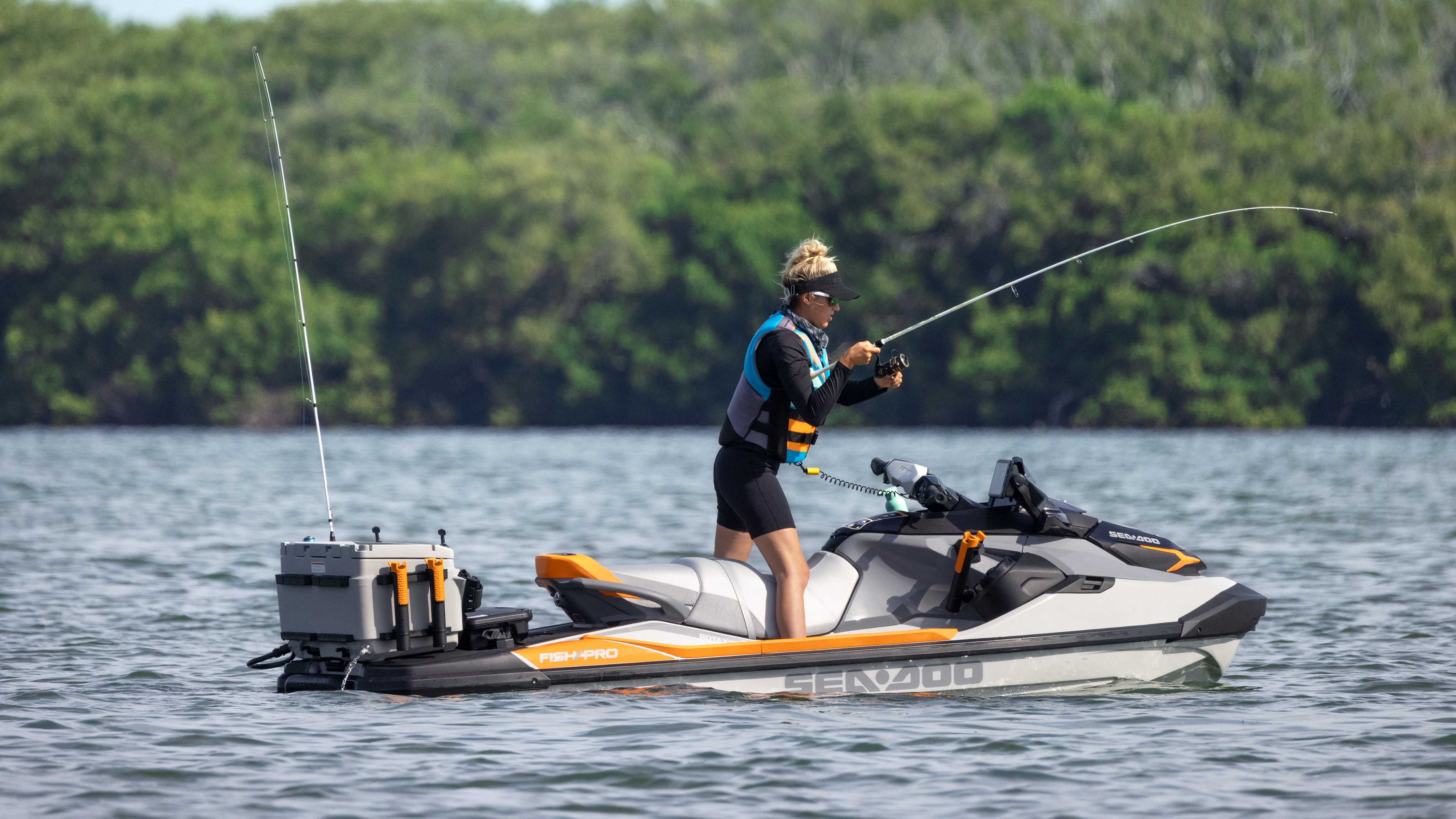 Woman standing on her Sea-Doo FishPro Trophy fullly equipped for fishing