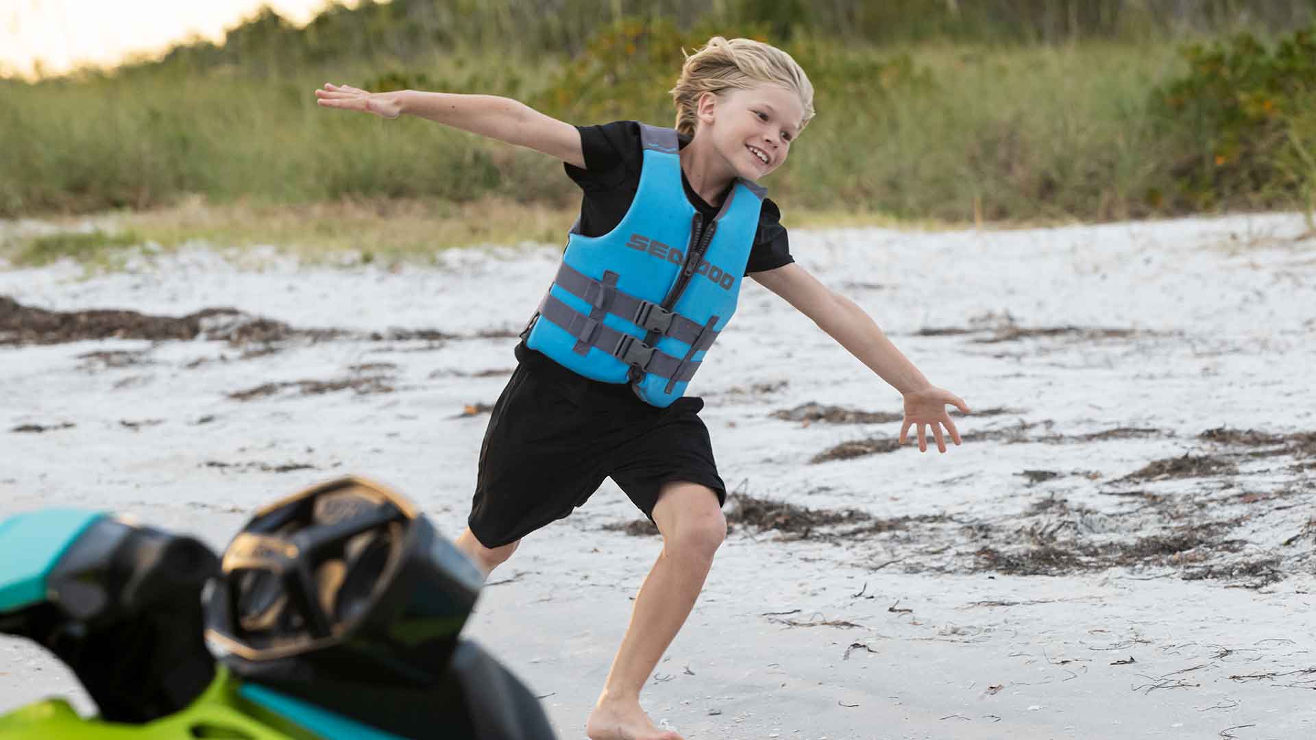 Kid running with his lifejacket