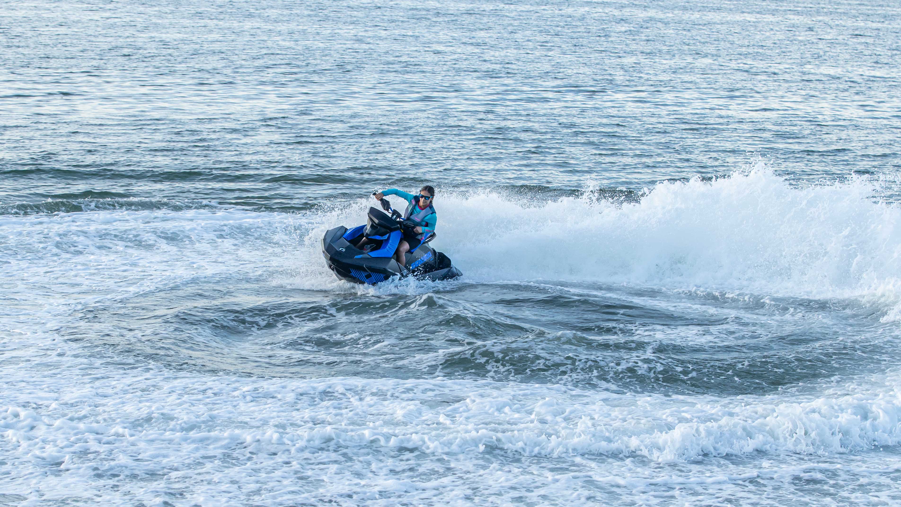Woman riding his blue Sea-Doo Spark
