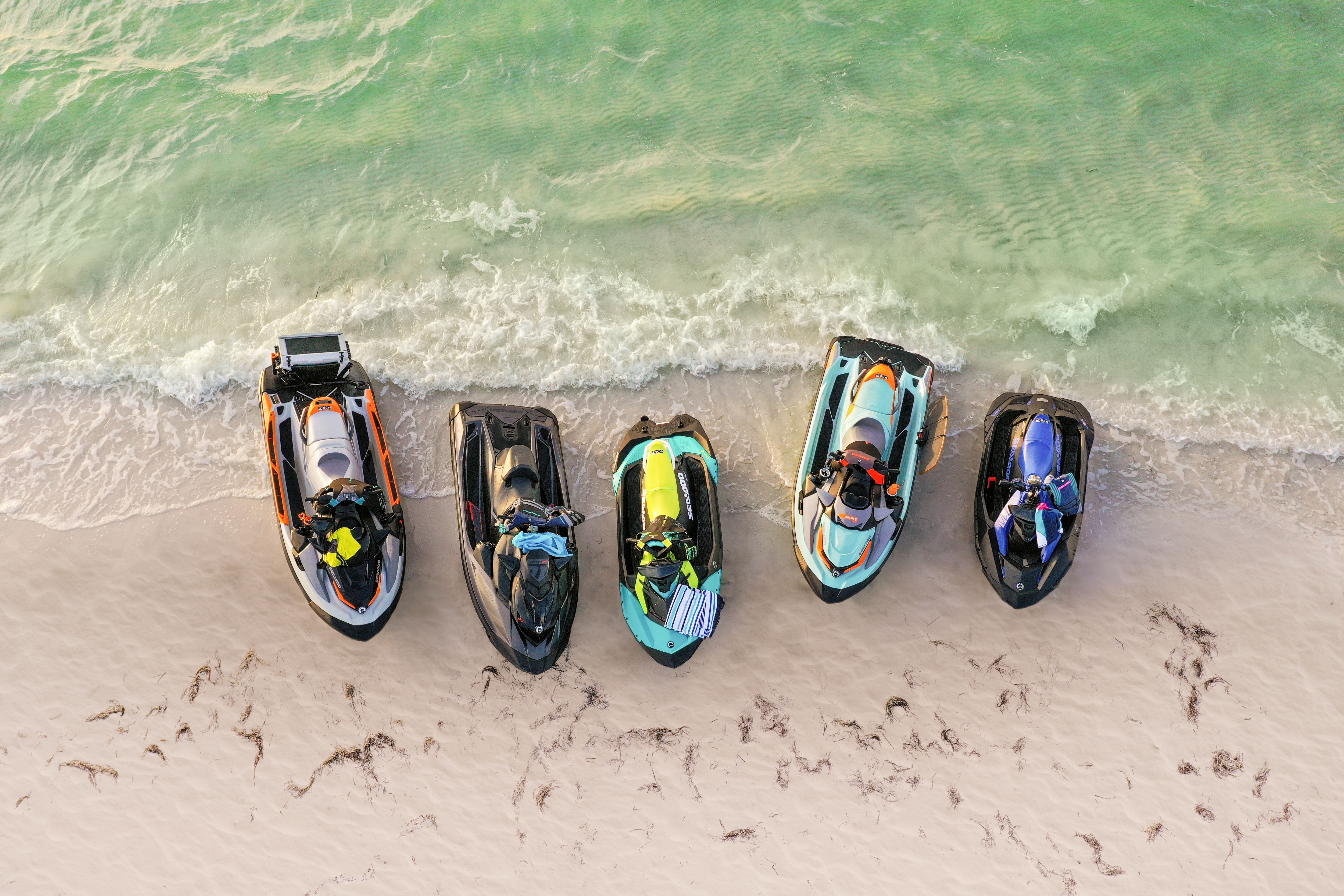 Sea-Doo vehicles lined up on the shore