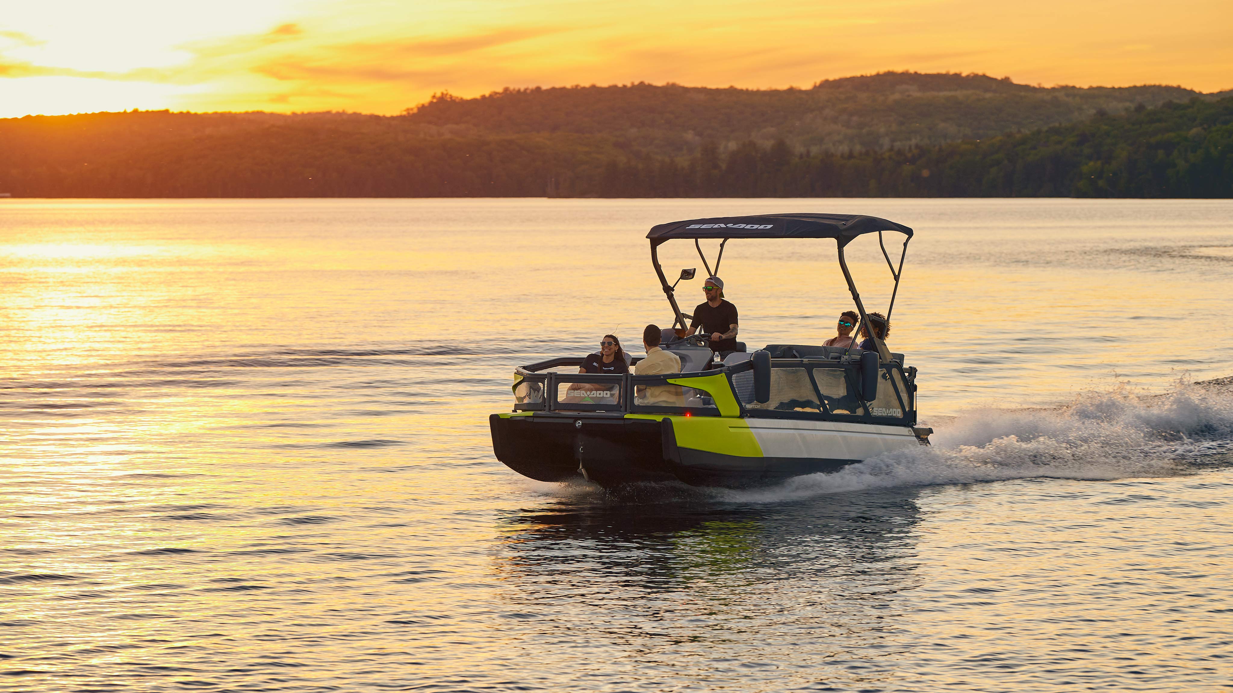 Sea-Doo Switch Sport cruising on a lake at sunset