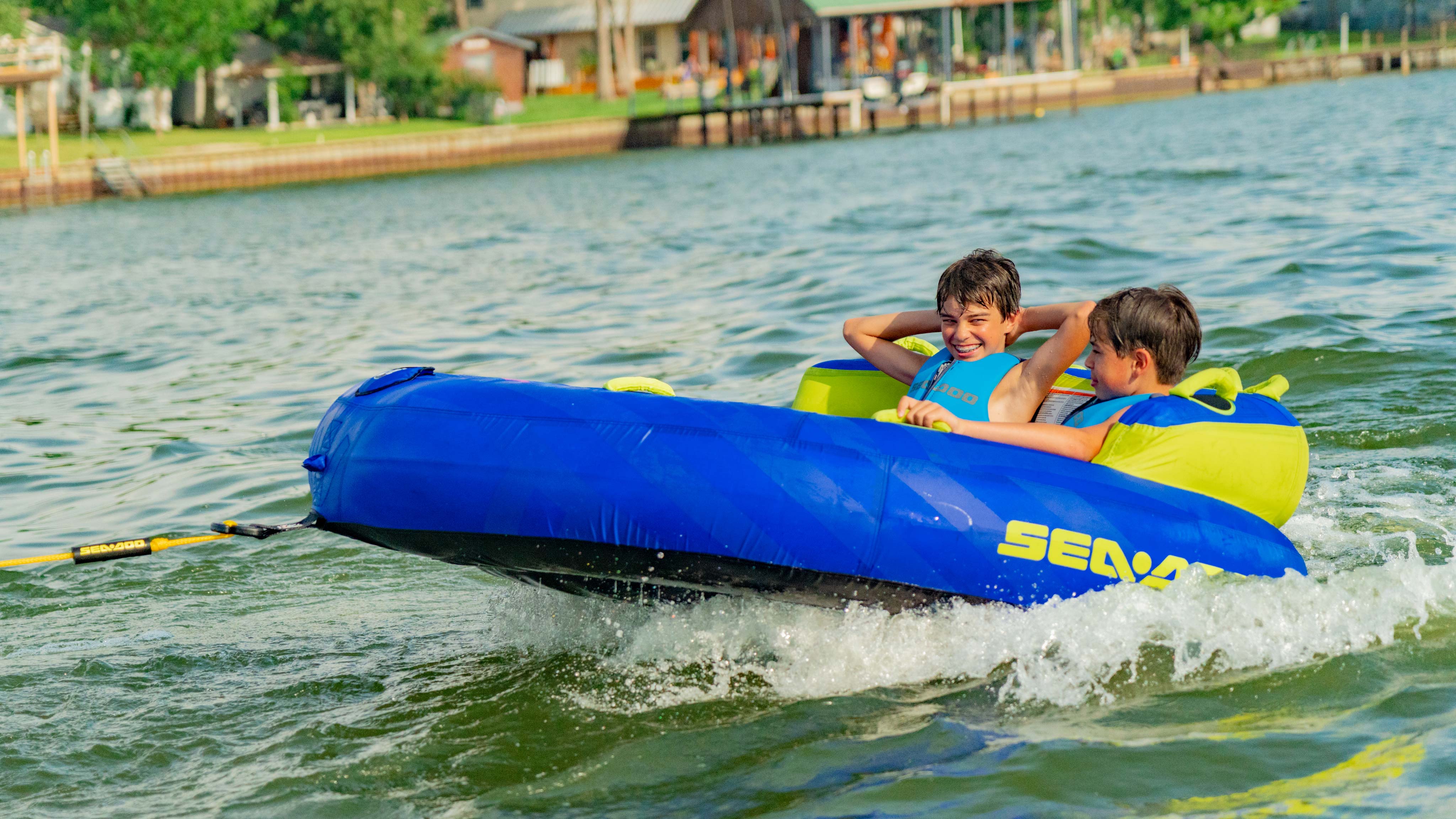 Kids having fun on a tube while being towed by a Sea-Doo SWITCH