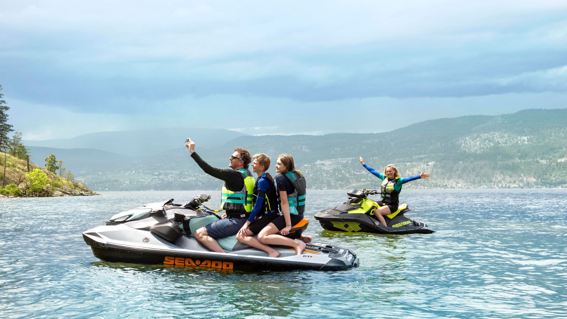 Family posing for a photo on Sea-Doo products.