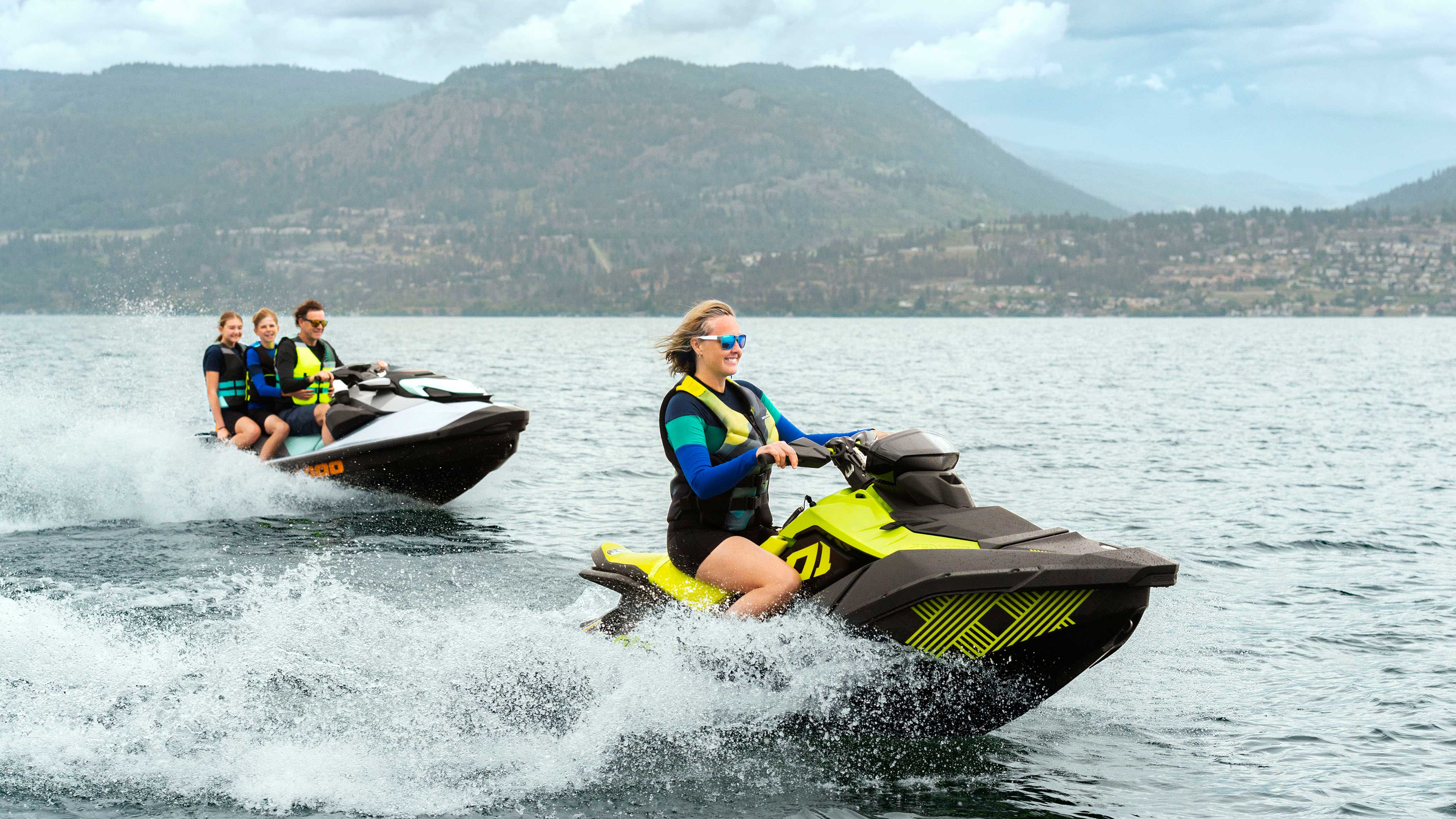 Family riding a Sea-Doo SPARK and a GTI