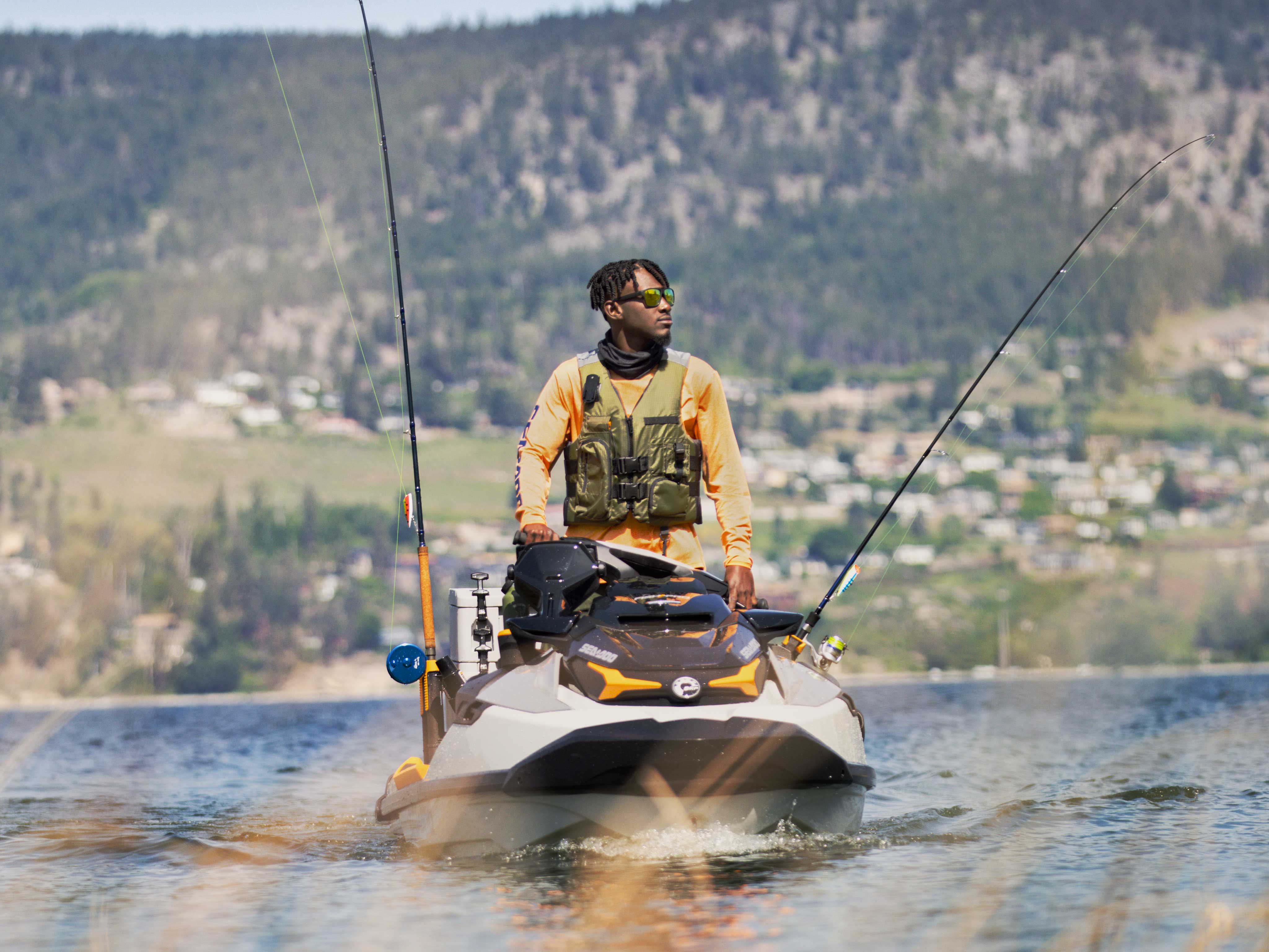 Man standing on the FISHPRO TROPHY wearing the Explorer PFD