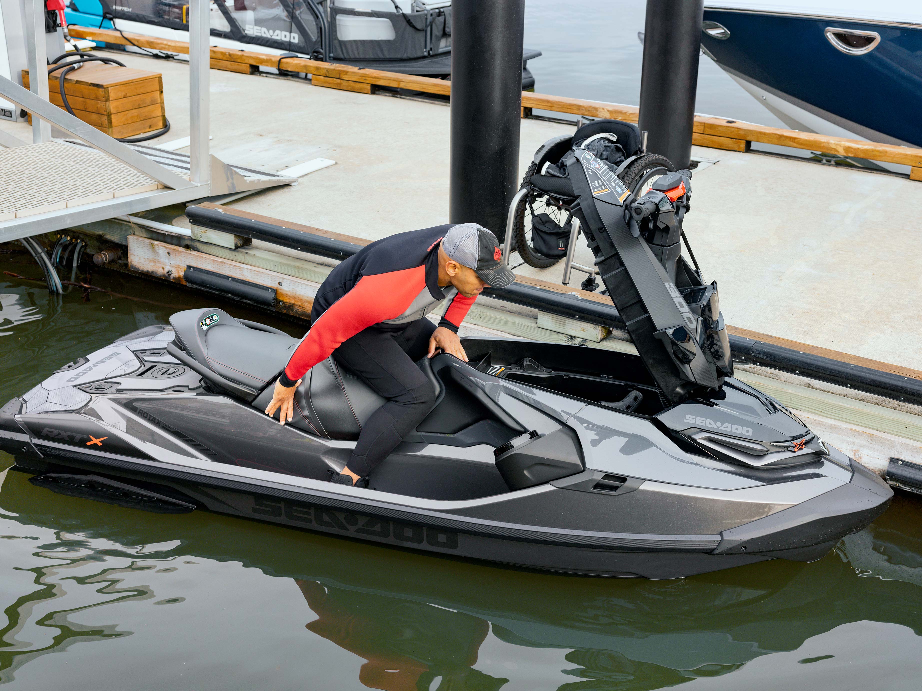 Man opening the front storage of the Sea-Doo RXT-X